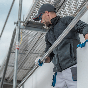 Tradesman holding on to railing