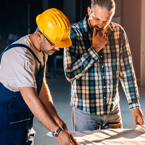 Tradesmen looking over paperwork
